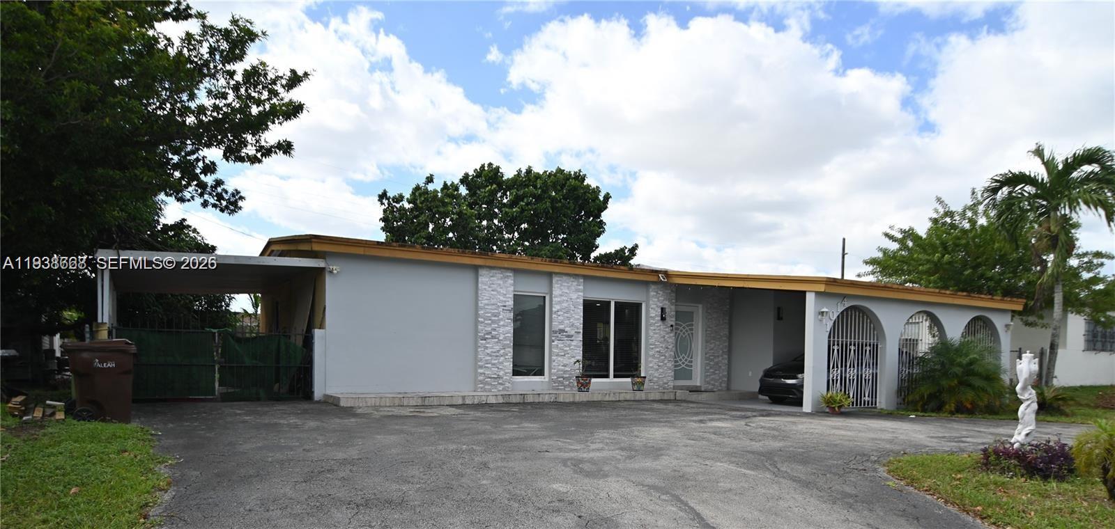 1014 West 68th Street Hialeah, FL 33014 - Photo 2 of 40 front view of a house with a yard