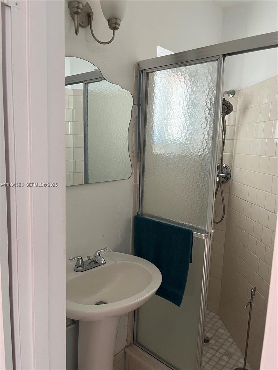 1014 West 68th Street Hialeah, FL 33014 - Photo 21 of 40 a bathroom with a sink toilet and shower