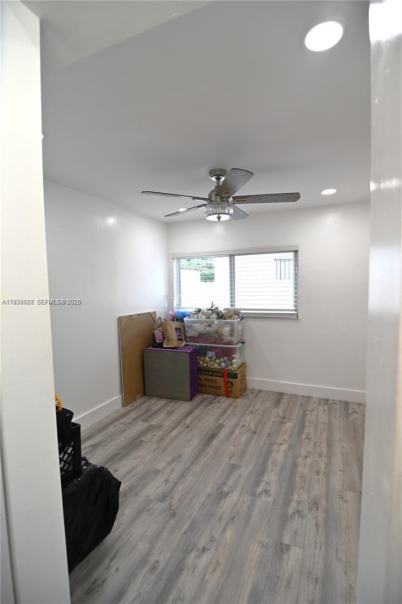 1014 West 68th Street Hialeah, FL 33014 - Photo 22 of 40 a living room with furniture and a flat screen tv