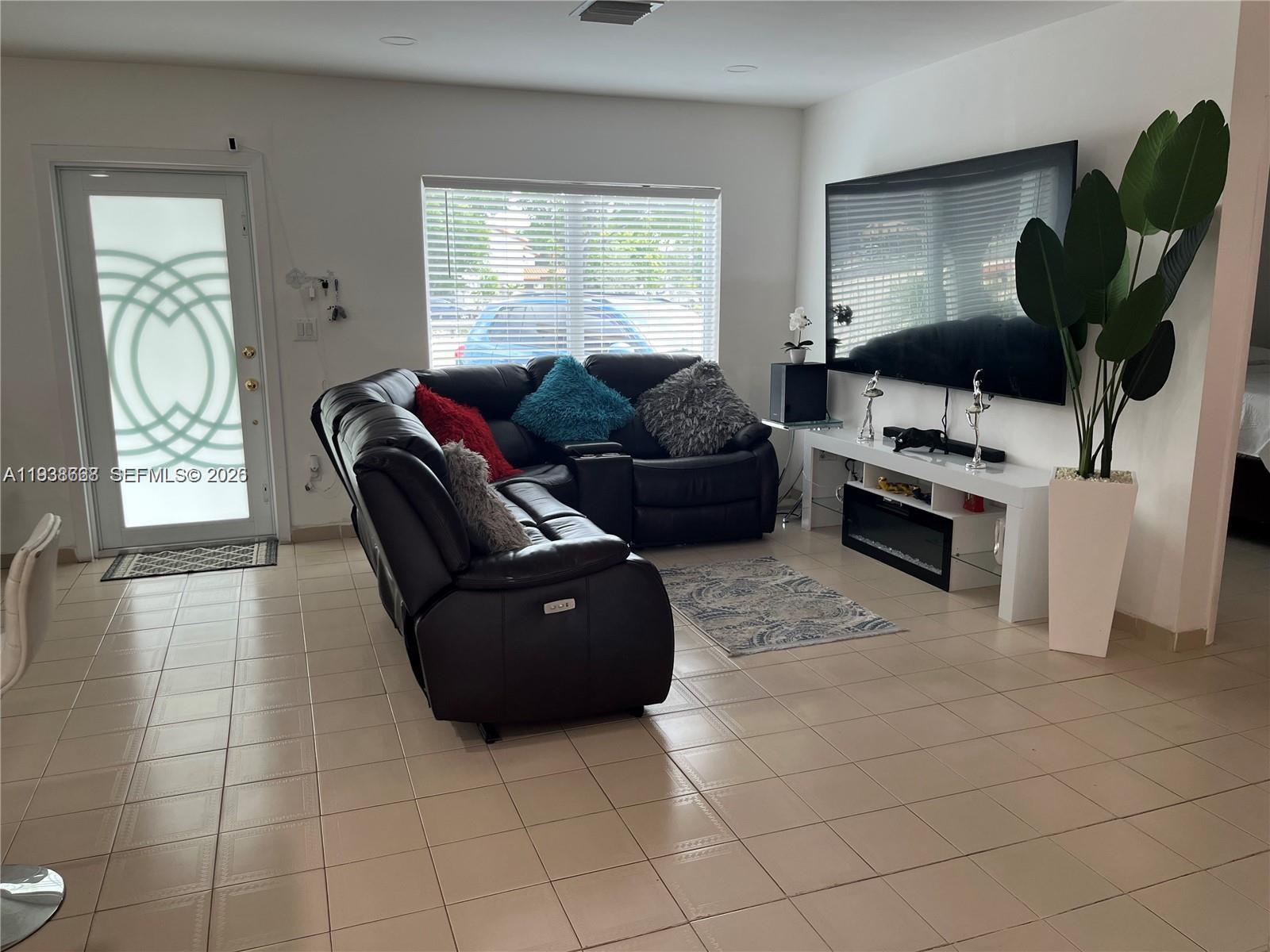 1014 West 68th Street Hialeah, FL 33014 - Photo 27 of 40 a living room with furniture and a window