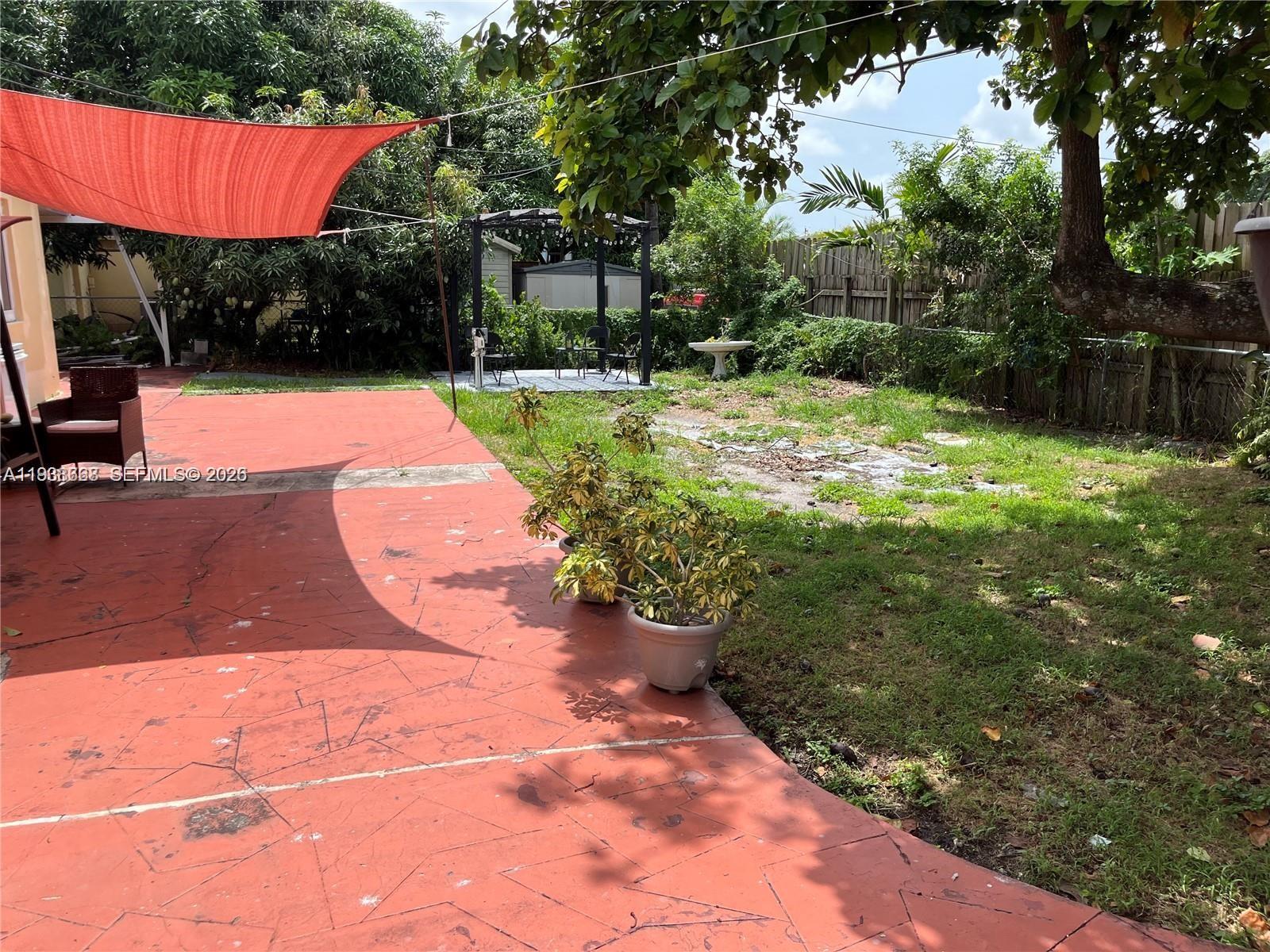 1014 West 68th Street Hialeah, FL 33014 - Photo 30 of 40 a view of backyard with swimming pool and outdoor seating