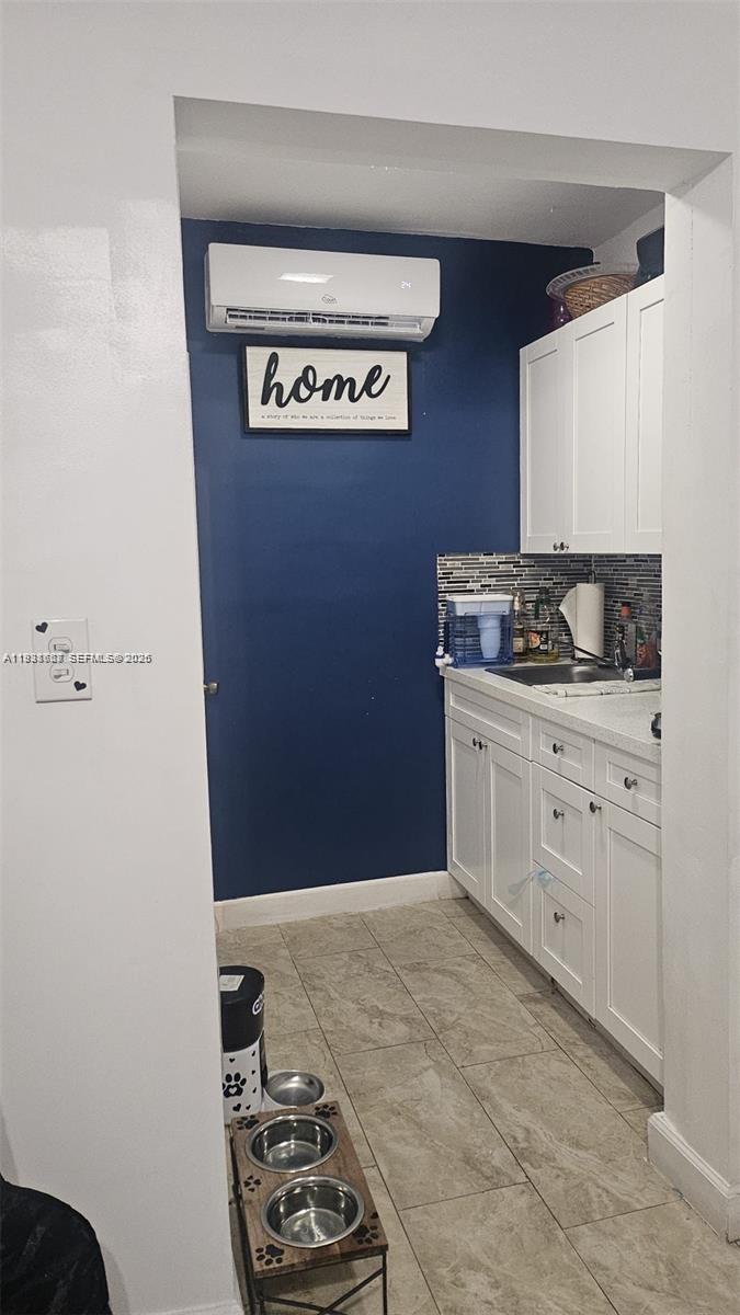 1014 West 68th Street Hialeah, FL 33014 - Photo 34 of 40 a view of cabinets with washer and dryer