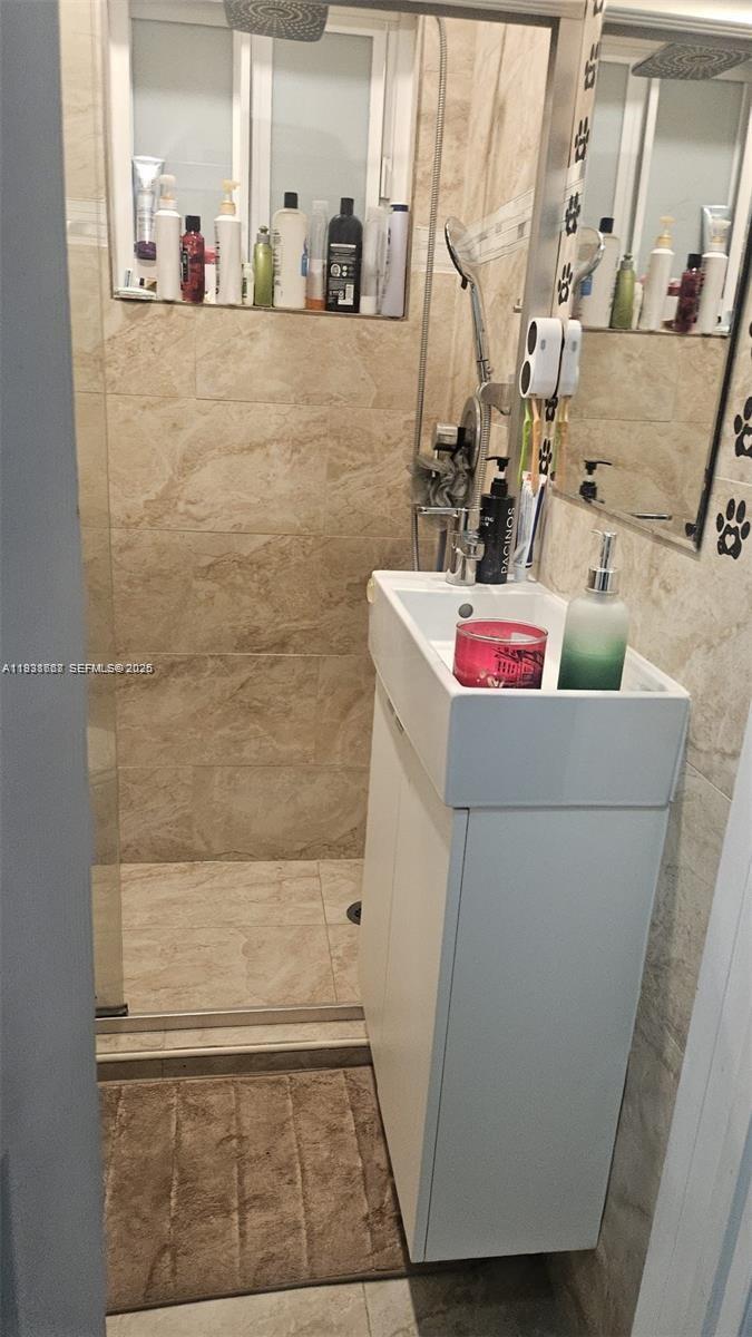 1014 West 68th Street Hialeah, FL 33014 - Photo 35 of 40 a bathroom with a sink and a mirror