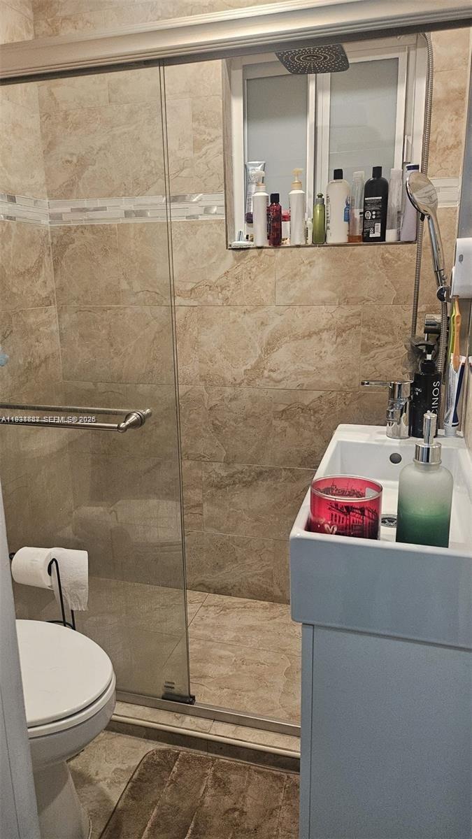 1014 West 68th Street Hialeah, FL 33014 - Photo 37 of 40 a bathroom with a toilet sink and shower