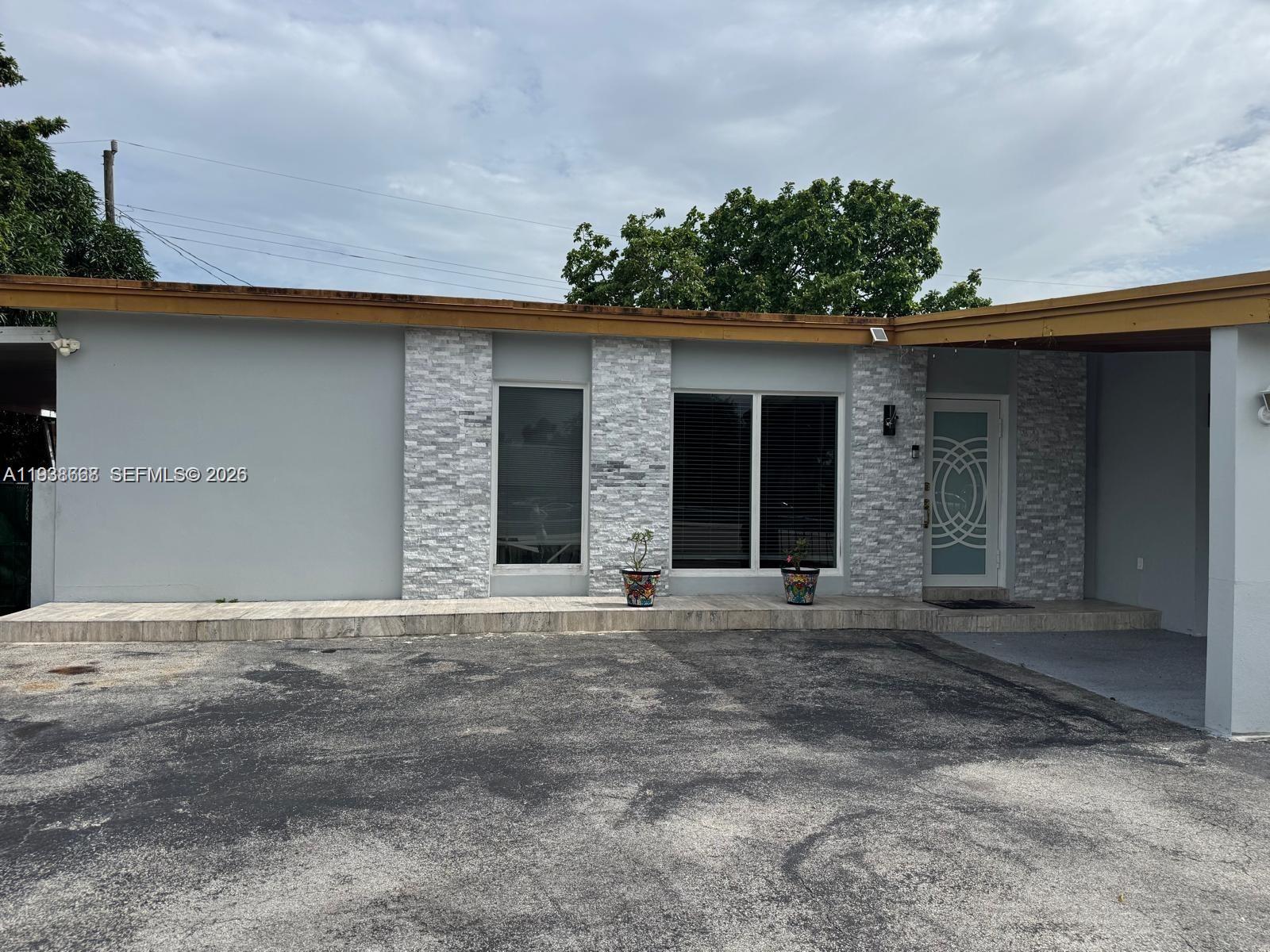 1014 West 68th Street Hialeah, FL 33014 - Photo 39 of 40 a front view of a house with a yard and garage