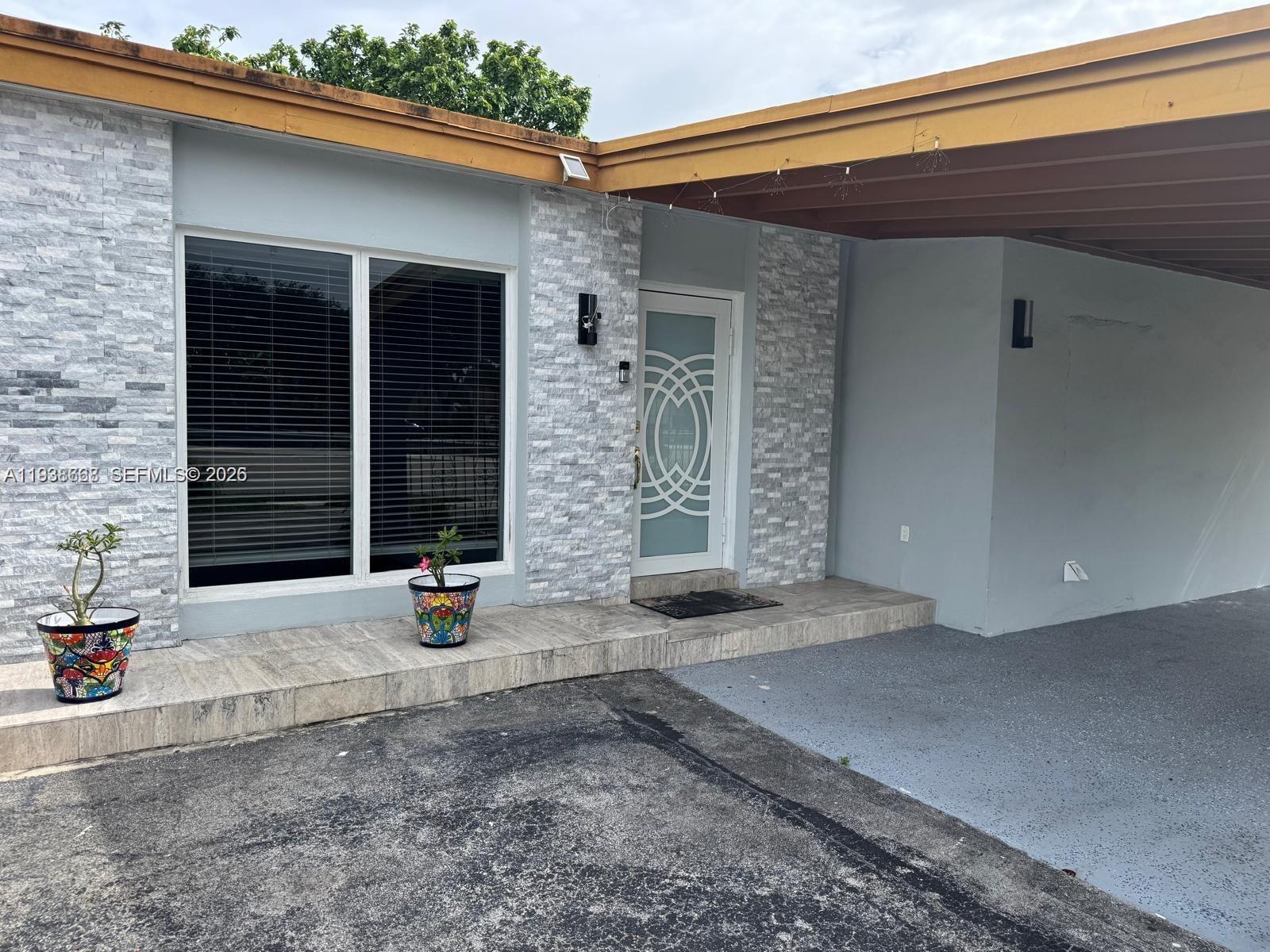 1014 West 68th Street Hialeah, FL 33014 - Photo 40 of 40 a view of a brick house with outdoor space
