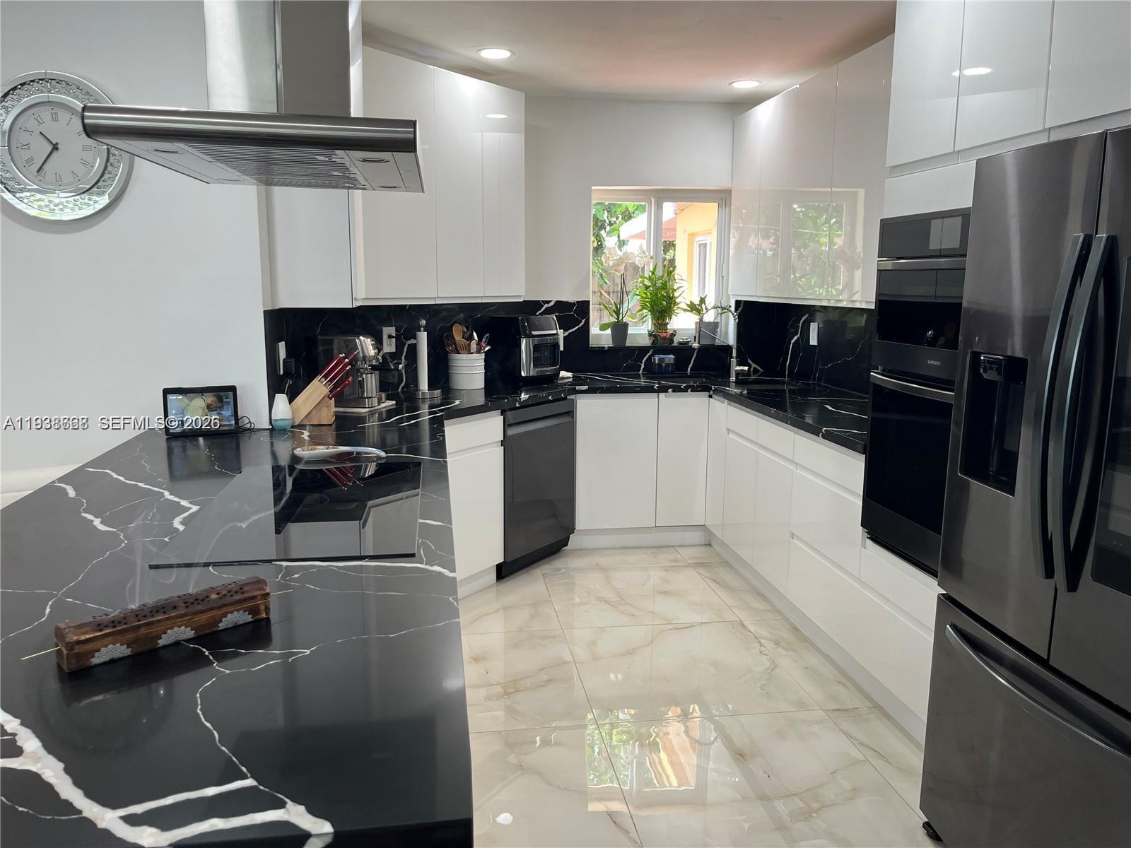 1014 West 68th Street Hialeah, FL 33014 - Photo 5 of 40 a kitchen with stainless steel appliances granite countertop a sink refrigerator and cabinets