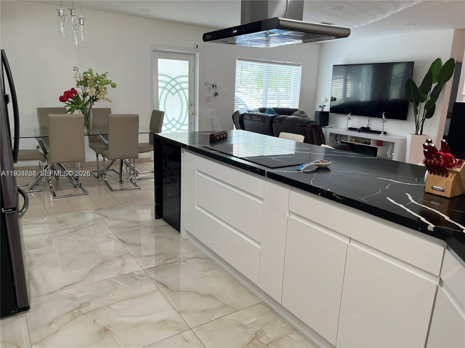 1014 West 68th Street Hialeah, FL 33014 - Photo 6 of 40 a kitchen with stainless steel appliances kitchen island granite countertop a sink and cabinets