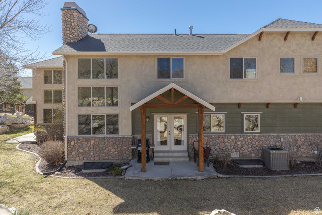 5168 Fairview Loop, Unit C604 Eden, UT 84310 - Photo 36 of 53 View of front facade with stone siding, a shingled roof, french doors, a chimney, and stucco siding