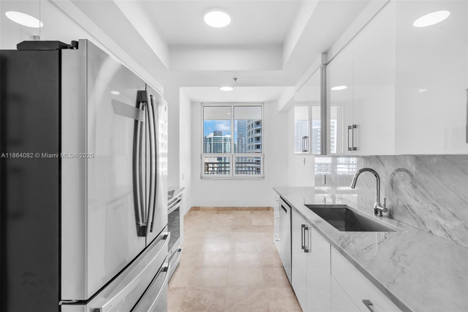808 Brickell Key Drive, Unit 3205 Miami, FL 33131 - Photo 13 of 51 a kitchen with stainless steel appliances a refrigerator and a sink
