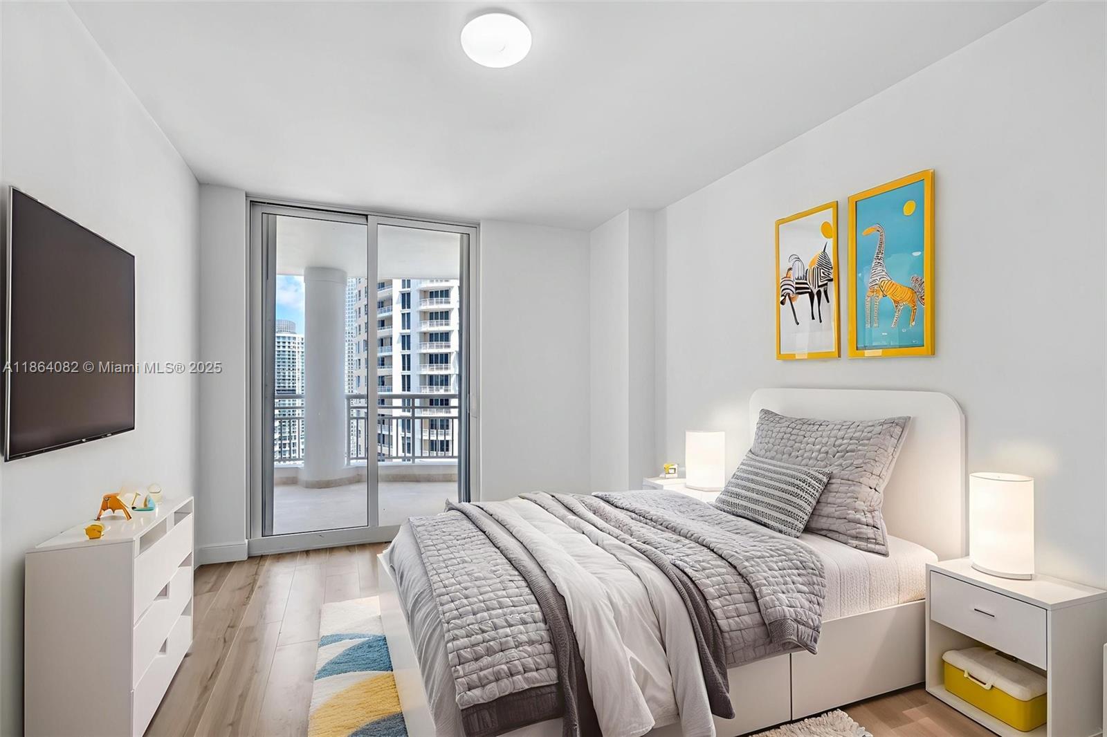 808 Brickell Key Drive, Unit 3205 Miami, FL 33131 - Photo 18 of 51 a bedroom with a bed and a flat screen tv