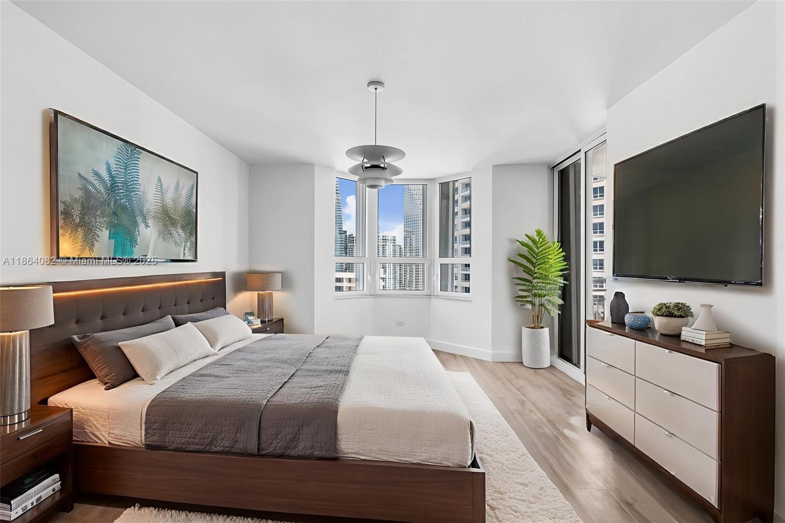 808 Brickell Key Drive, Unit 3205 Miami, FL 33131 - Photo 24 of 51 a bedroom with a bed and a flat screen tv