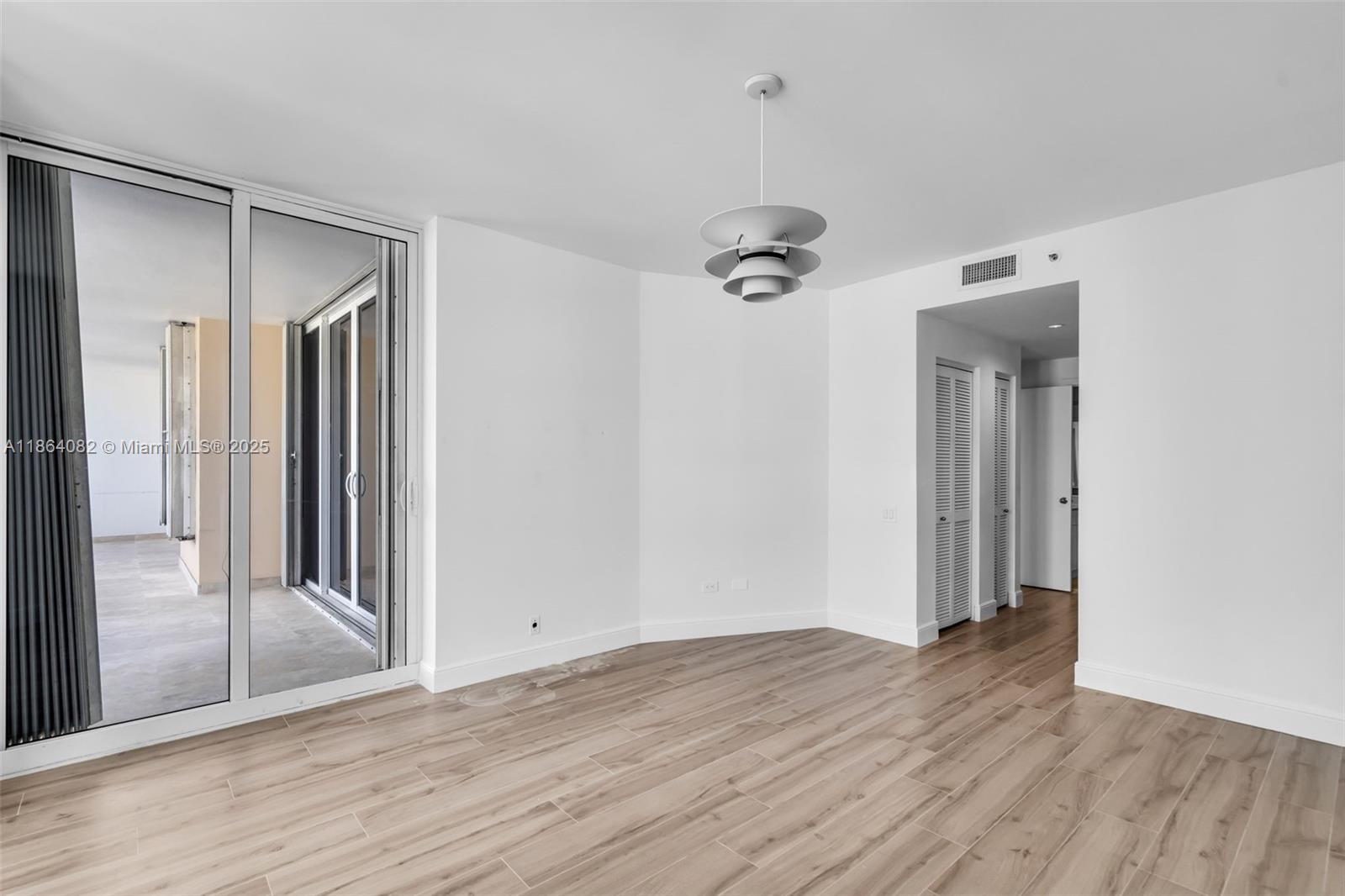 808 Brickell Key Drive, Unit 3205 Miami, FL 33131 - Photo 25 of 51 an empty room with wooden floor and entrance