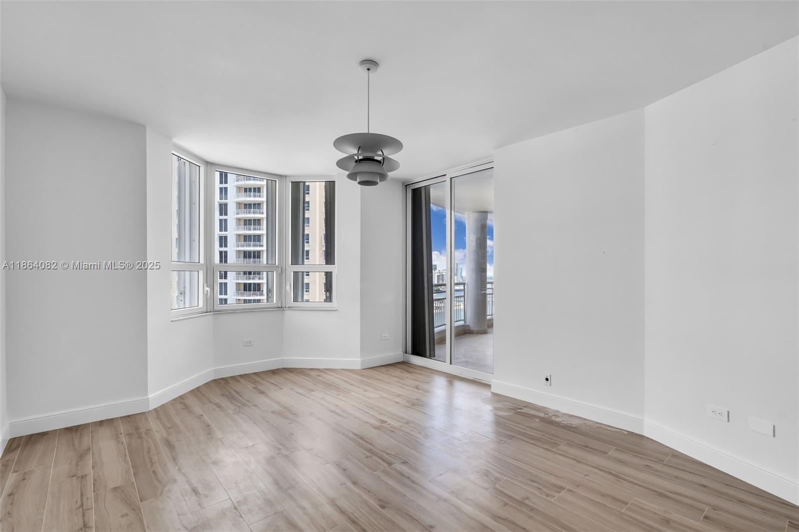 808 Brickell Key Drive, Unit 3205 Miami, FL 33131 - Photo 26 of 51 a view of an empty room with wooden floor and a window