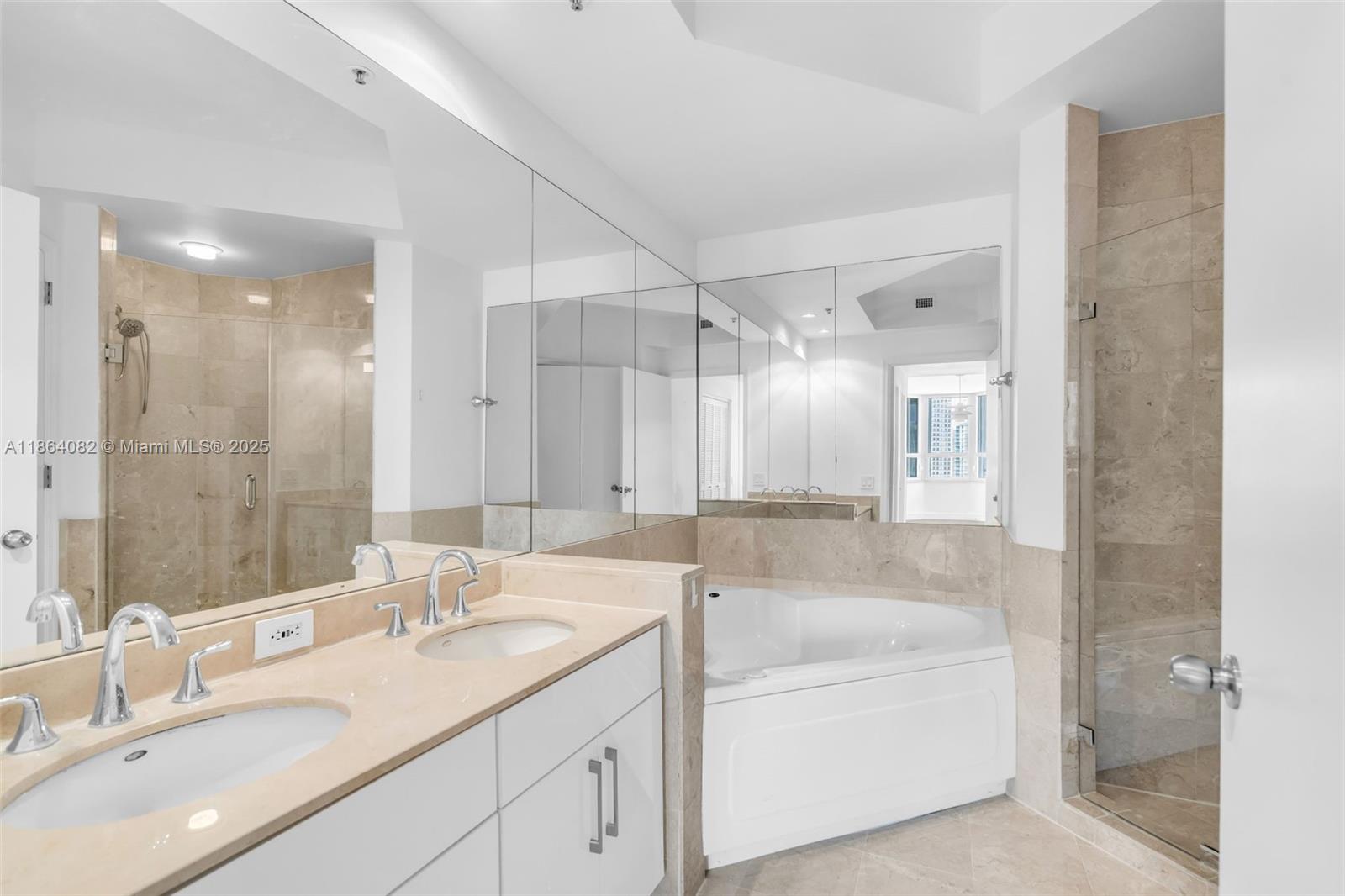 808 Brickell Key Drive, Unit 3205 Miami, FL 33131 - Photo 29 of 51 a bathroom with a tub sink double and mirror