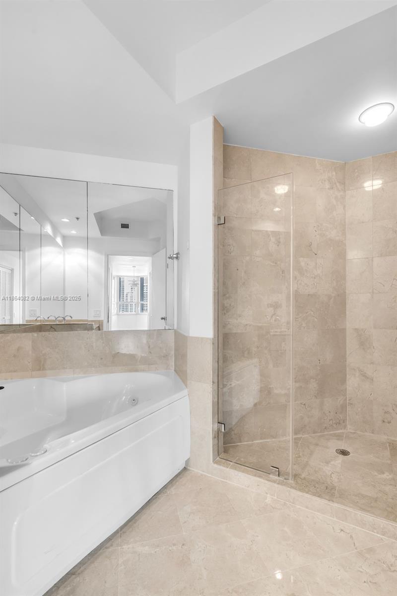 808 Brickell Key Drive, Unit 3205 Miami, FL 33131 - Photo 30 of 51 a spacious bathroom with a bathtub and shower