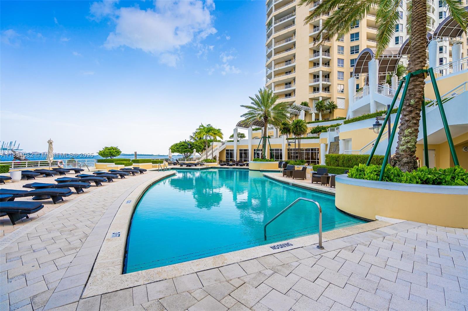 808 Brickell Key Drive, Unit 3205 Miami, FL 33131 - Photo 40 of 51 a swimming pool with outdoor seating and yard