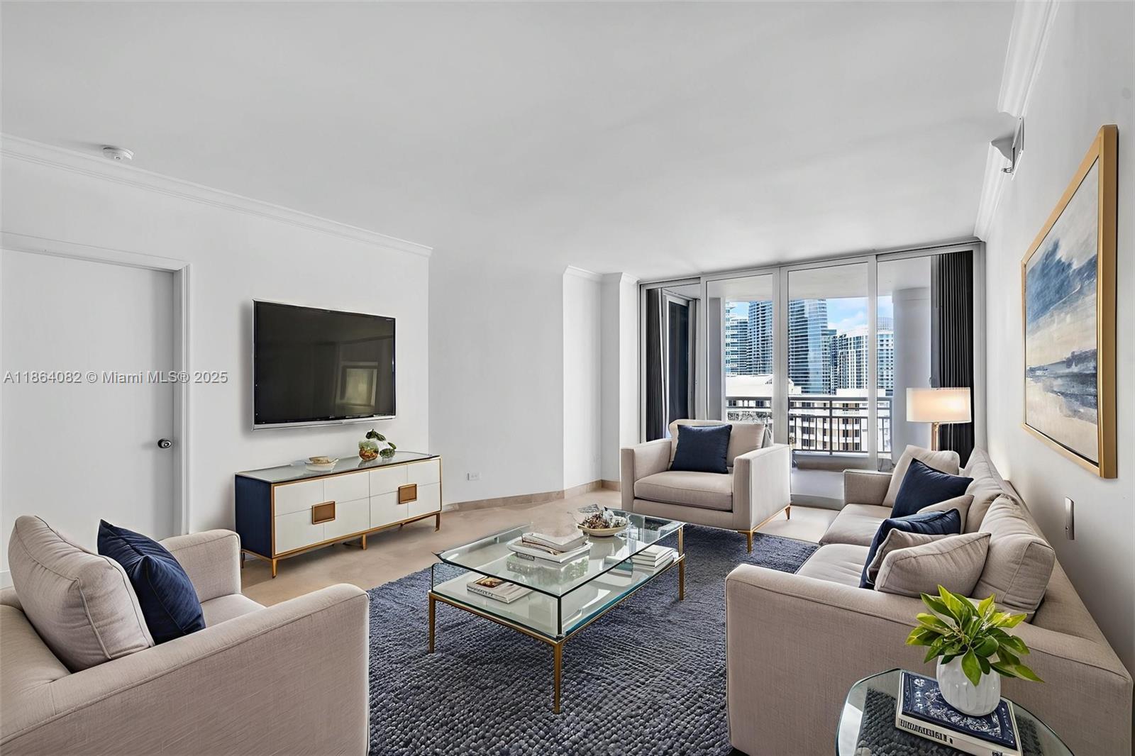 808 Brickell Key Drive, Unit 3205 Miami, FL 33131 - Photo 7 of 51 a living room with furniture a flat screen tv and a large window