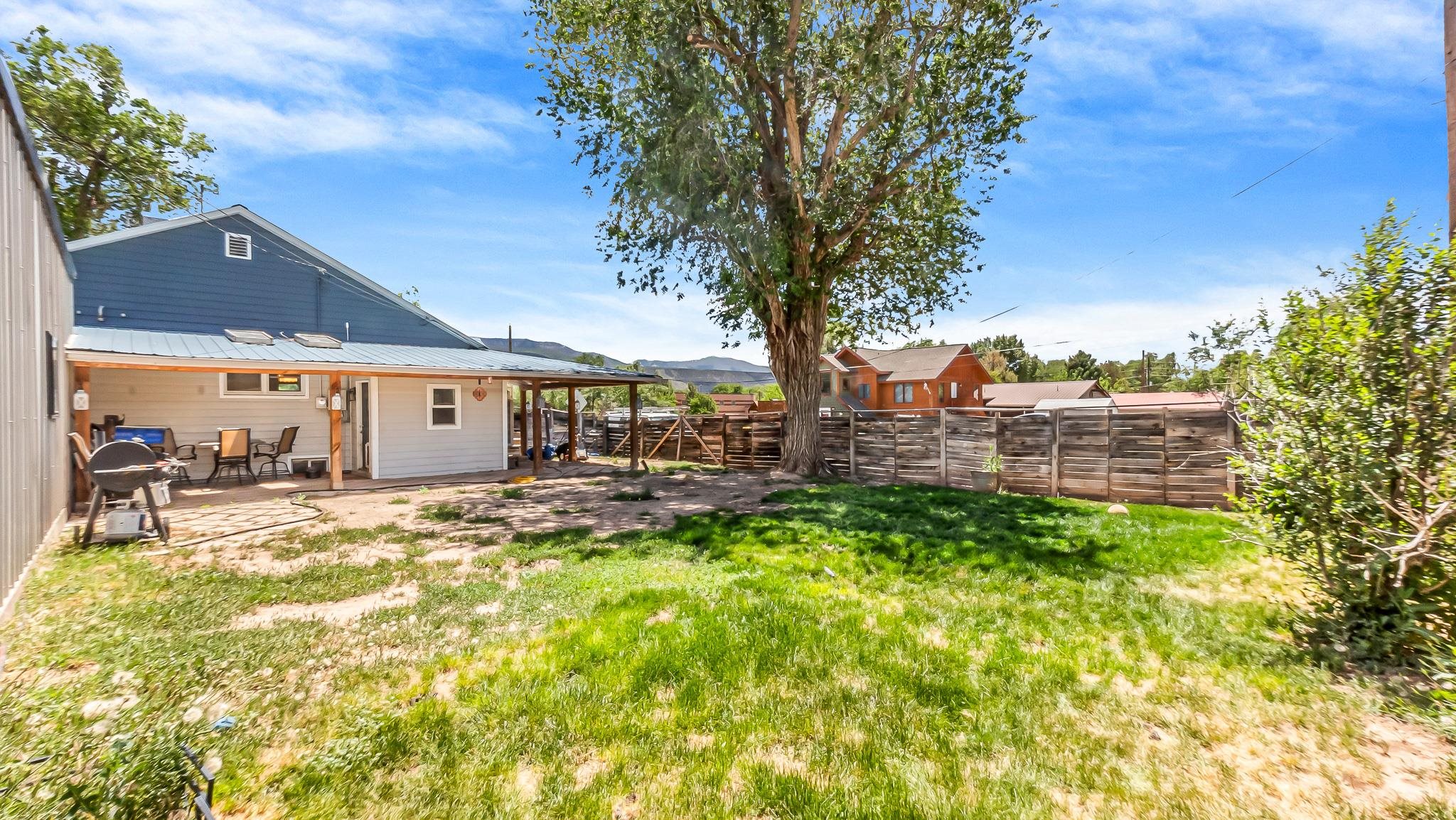 208 3rd Street Parachute, CO 81635 - Photo 37 of 40 a view of a house with backyard porch and sitting area