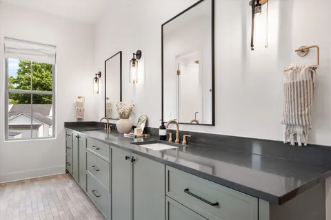 a bathroom with a granite countertop sink and a mirror