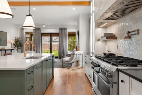 a kitchen with stainless steel appliances a refrigerator and cabinets
