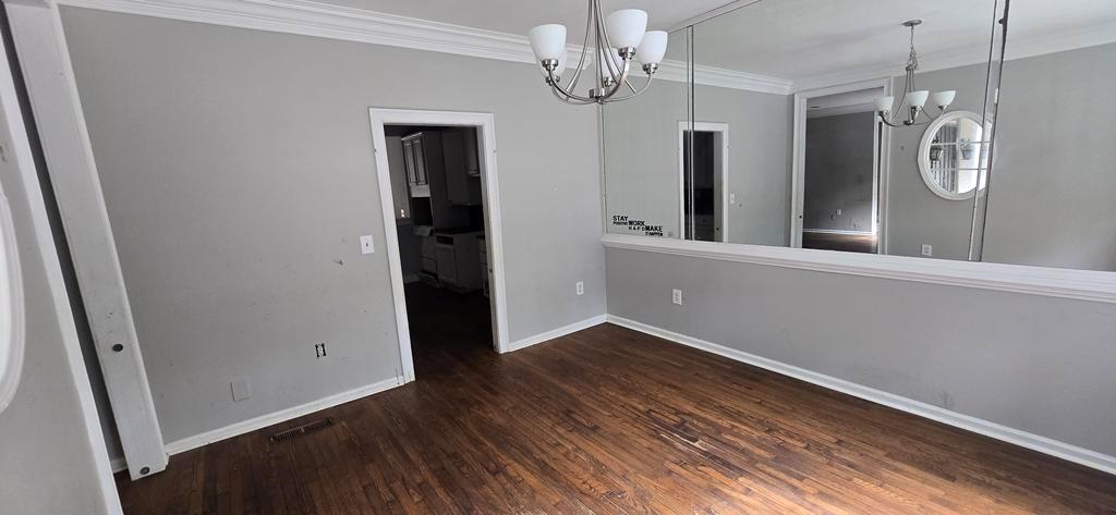 4119 Waits Avenue Southwest Atlanta, GA 30331 - Photo 4 of 15 an empty room with wooden floor and mirror