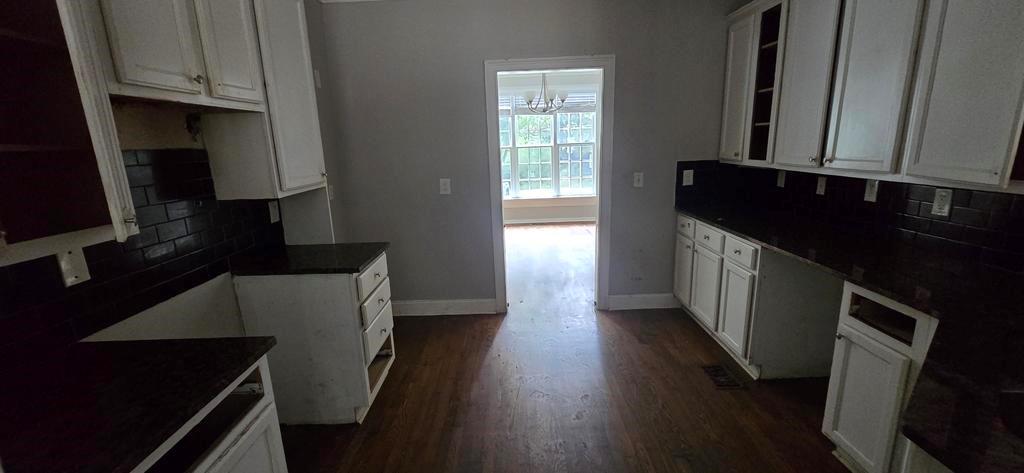 4119 Waits Avenue Southwest Atlanta, GA 30331 - Photo 6 of 15 a kitchen with granite countertop a stove a sink and a microwave