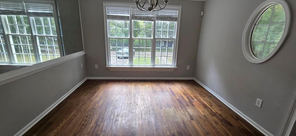 4119 Waits Avenue Southwest Atlanta, GA 30331 - Photo 7 of 15 an empty room with wooden floor and windows
