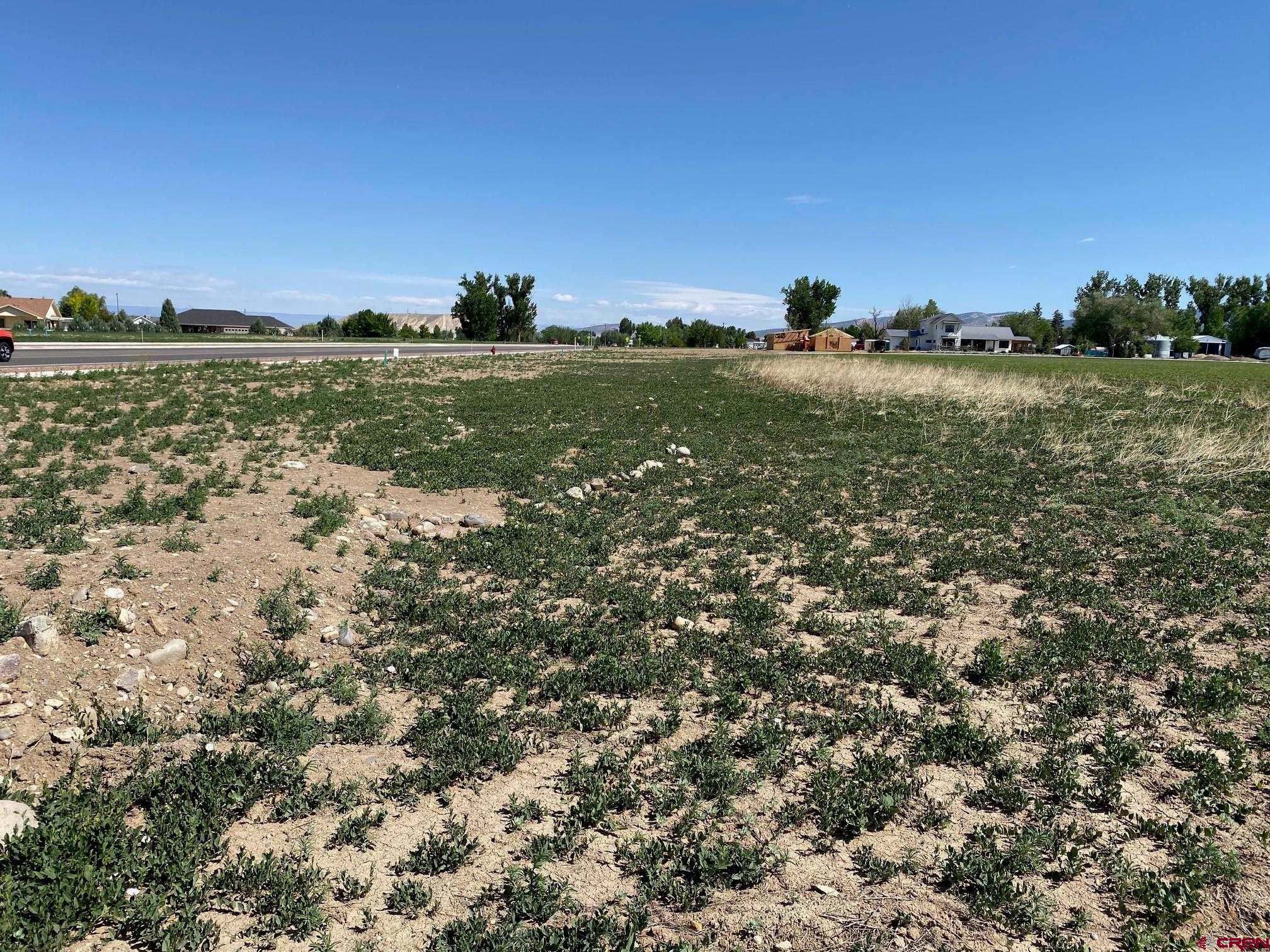 Lot 11 6700th Road Montrose, CO 81401 - Photo 8 of 8 a view of a lake with a building in the background