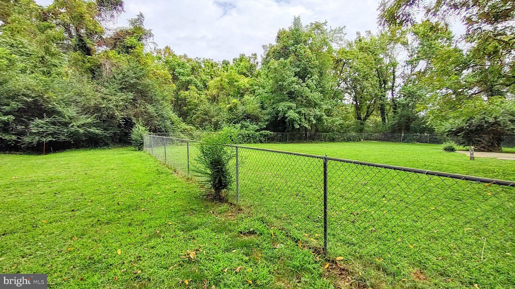 15240 Point Lookout Road St. Inigoes, MD 20684 - Photo 8 of 24 Yard goes beyond the fence