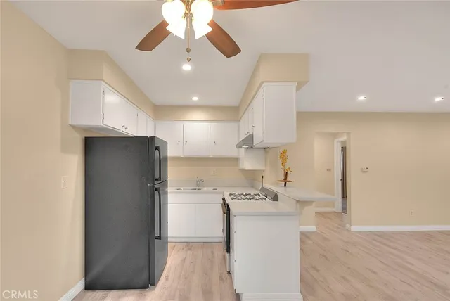 a kitchen with stainless steel appliances a refrigerator sink and cabinets