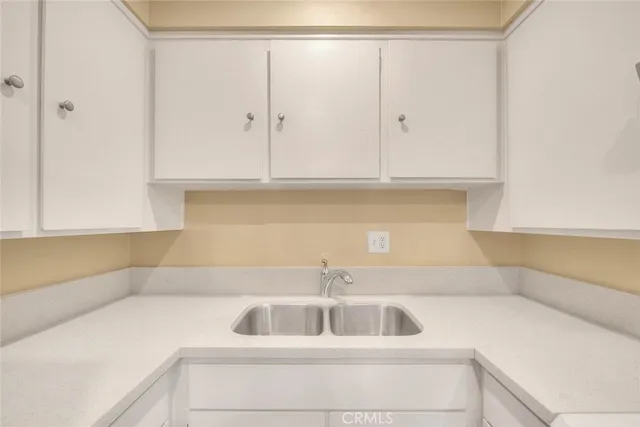 a kitchen with stainless steel appliances a refrigerator sink and cabinets