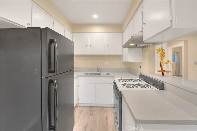 a kitchen with a refrigerator and cabinets