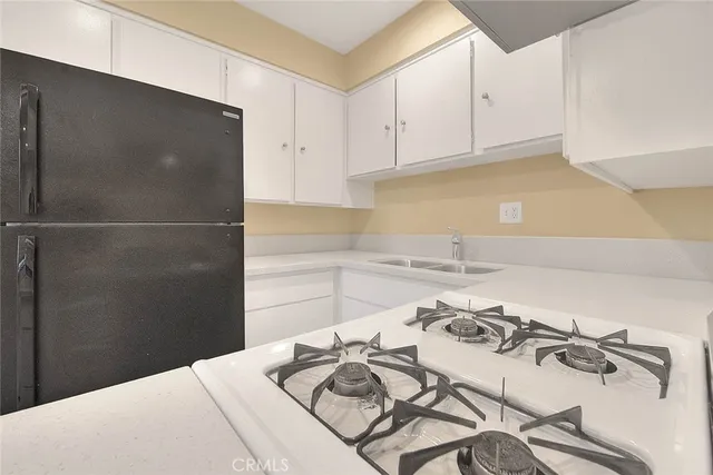 an empty room with a ceiling fan and a window