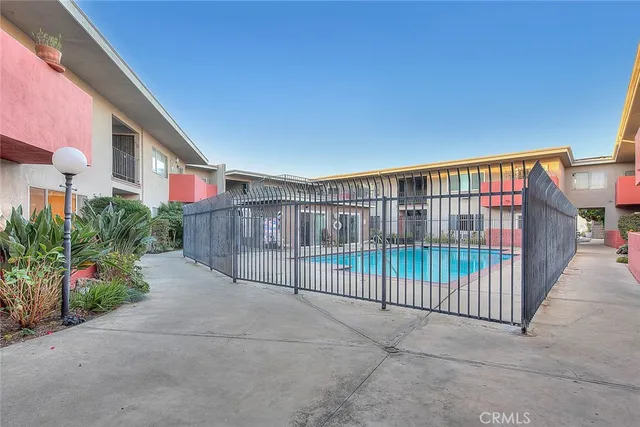 a view of a house next to a yard with big trees