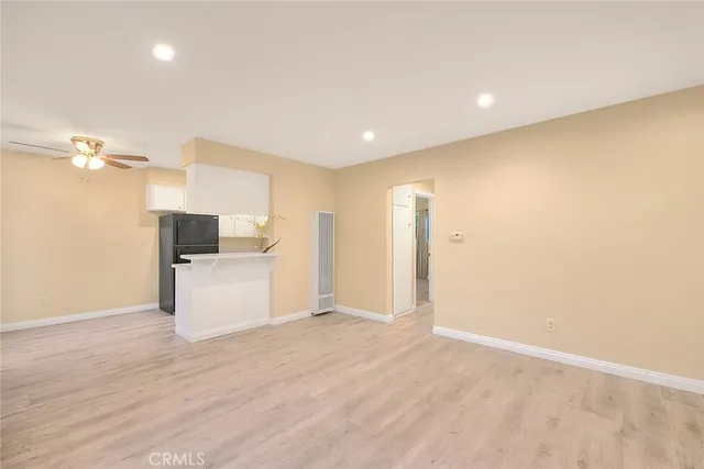 a view of a kitchen with a sink and a refrigerator