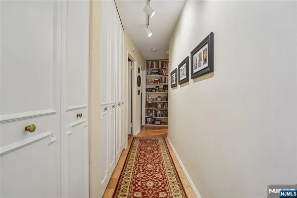 a view of a hallway with wooden floor and entryway