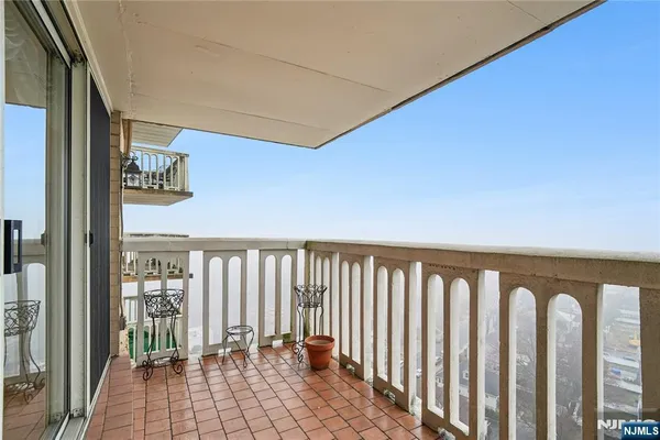 a view of a balcony with wooden floor