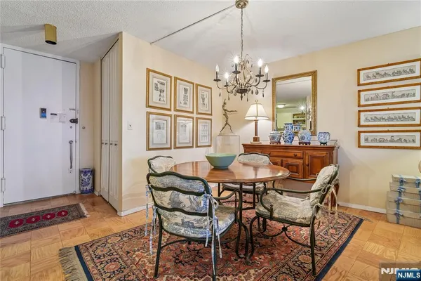 a view of a dining room with furniture and chandelier