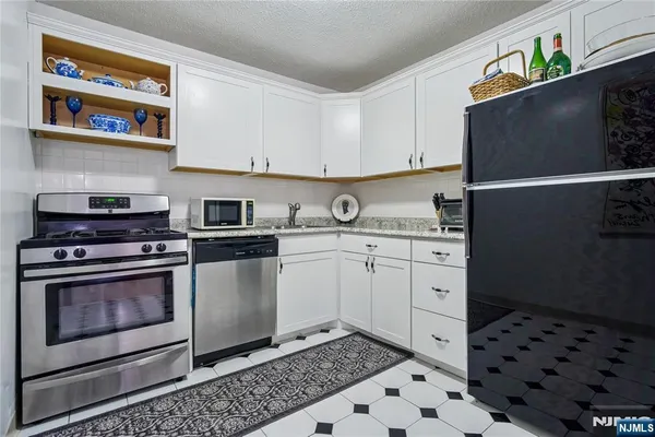 a kitchen with appliances cabinets and a counter top space