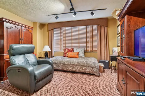 a bedroom with furniture and large windows