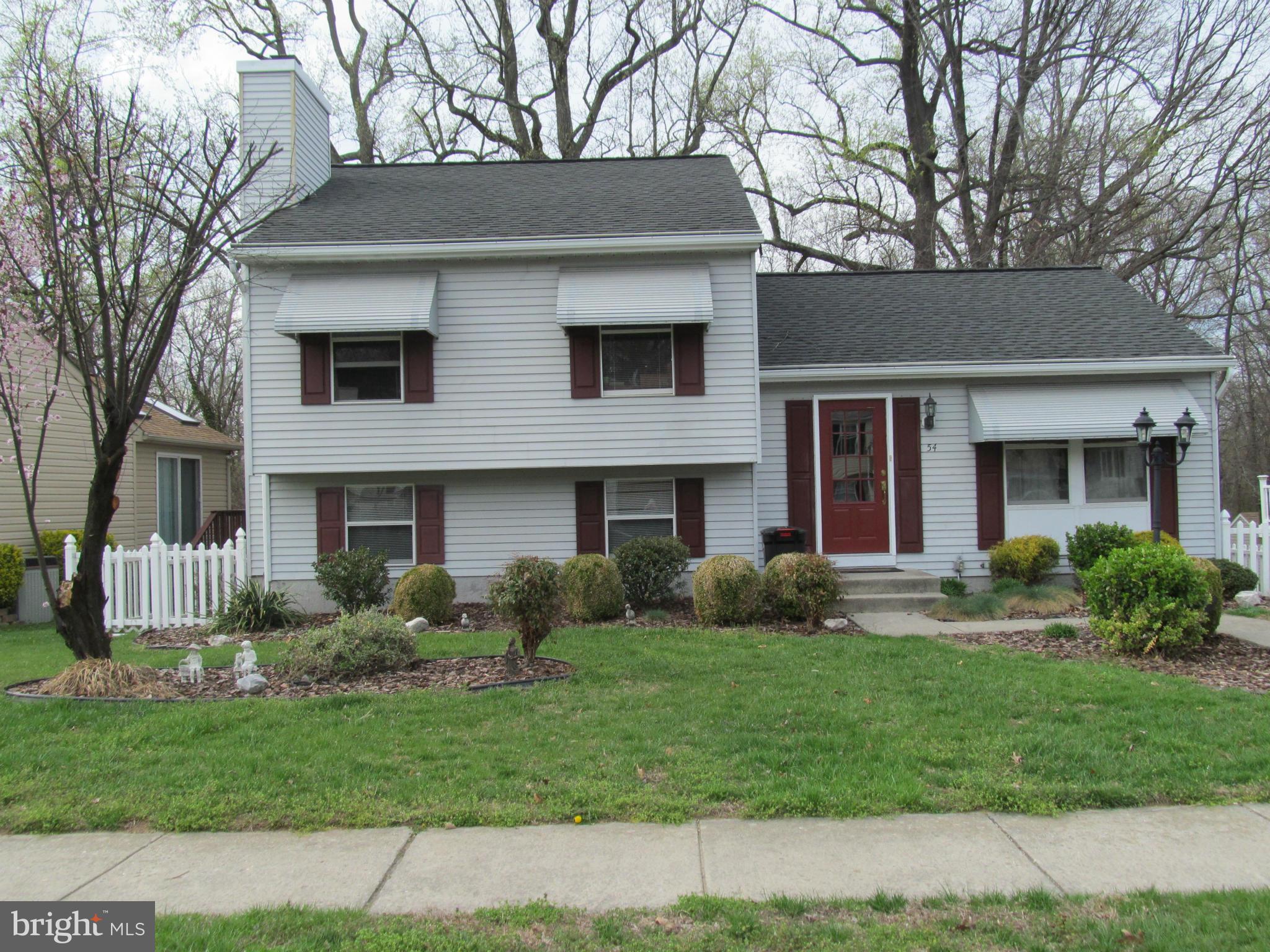54 Yew Road Baltimore, MD 21221 - Photo 1 of 28 a front view of a house with a yard and garage