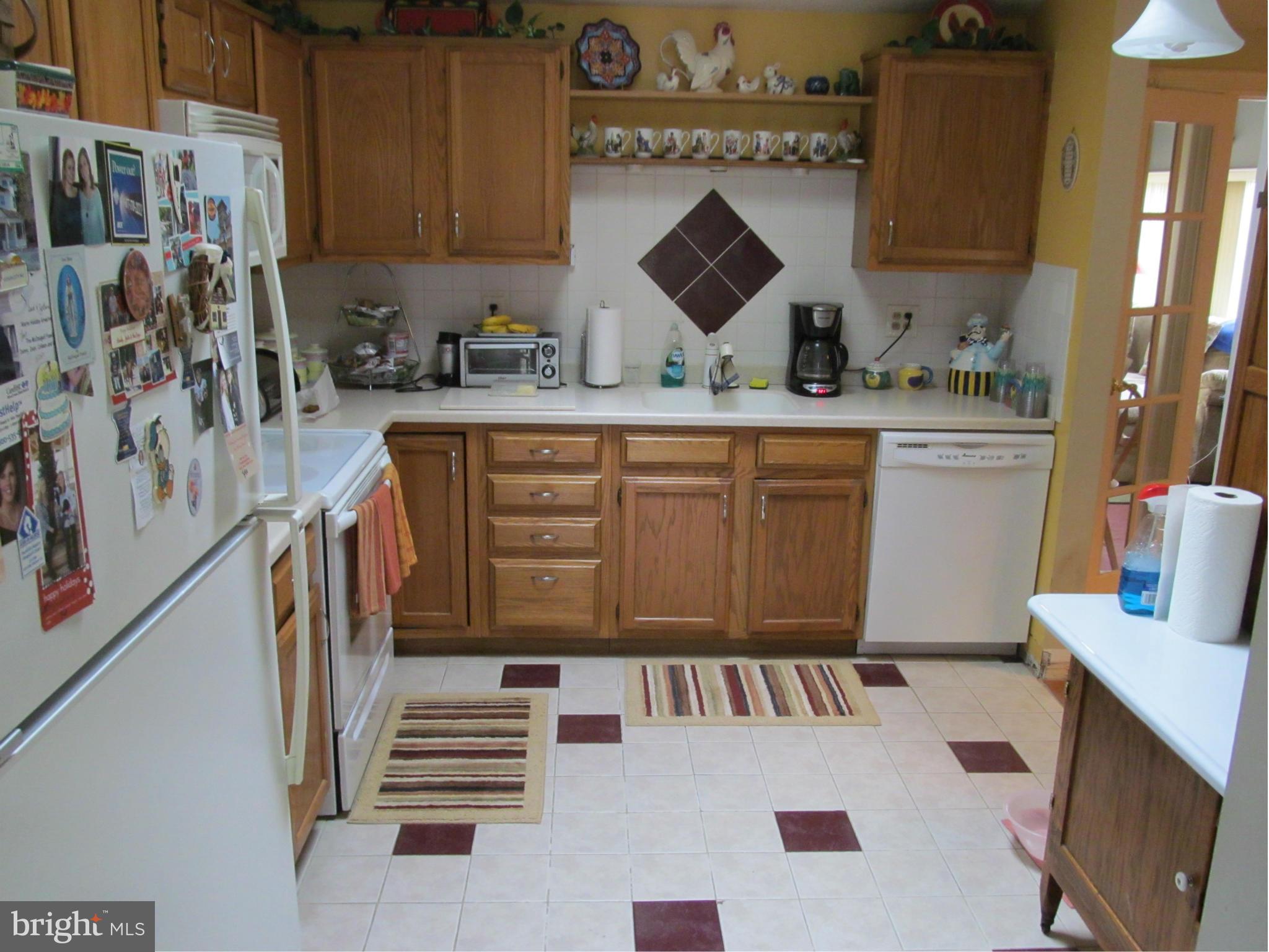 54 Yew Road Baltimore, MD 21221 - Photo 11 of 28 a kitchen with stainless steel appliances a stove a sink and a refrigerator