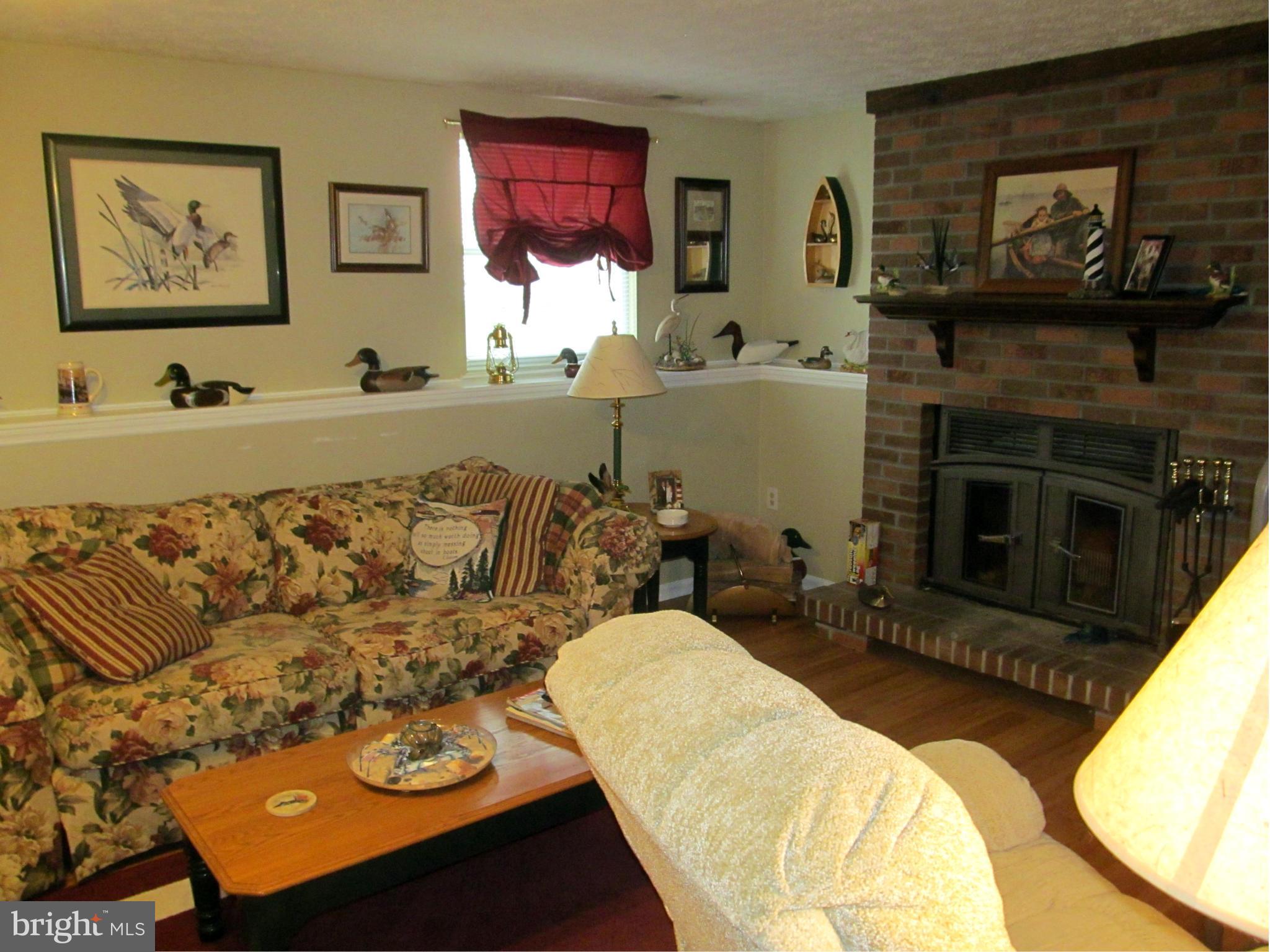 54 Yew Road Baltimore, MD 21221 - Photo 13 of 28 a living room with furniture and a fireplace