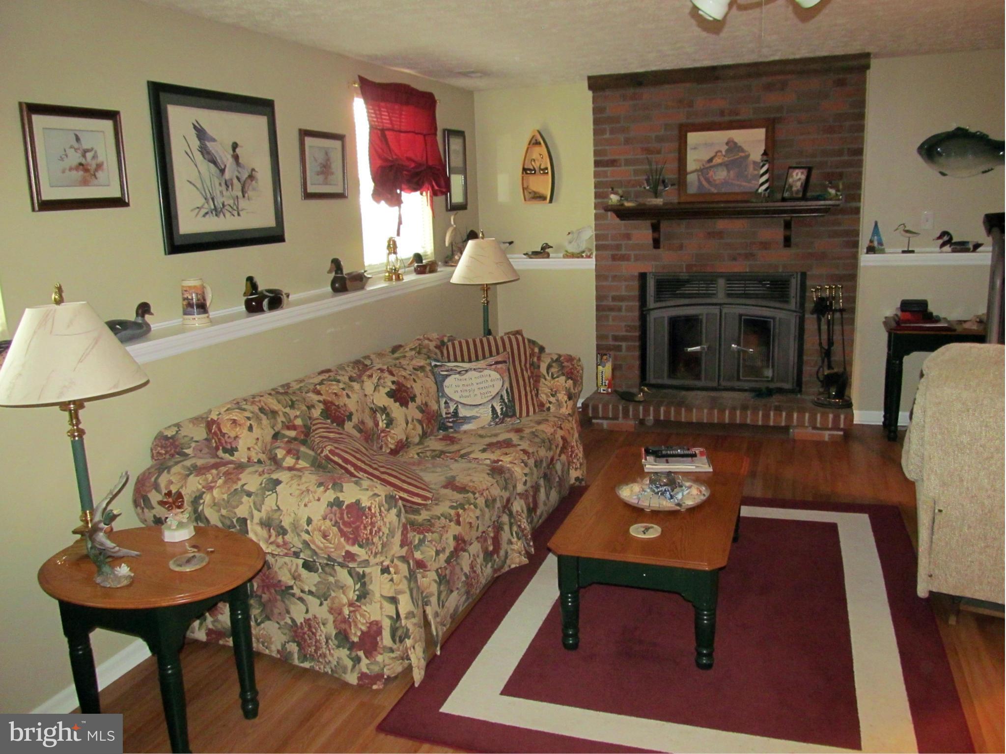 54 Yew Road Baltimore, MD 21221 - Photo 14 of 28 a living room with furniture a fireplace and a flat screen tv