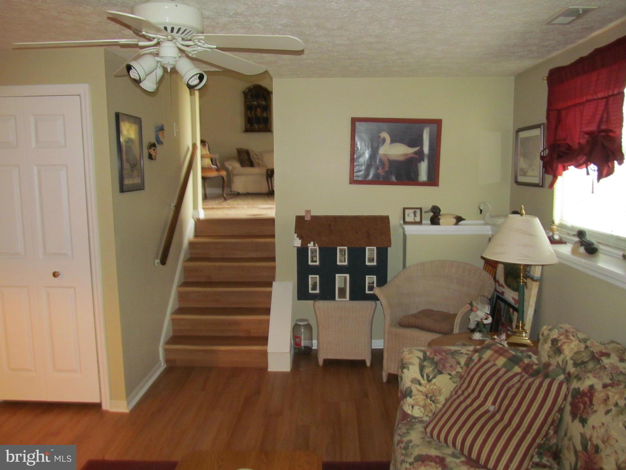 54 Yew Road Baltimore, MD 21221 - Photo 15 of 28 a view of a livingroom with furniture wooden floor windows and a chandelier