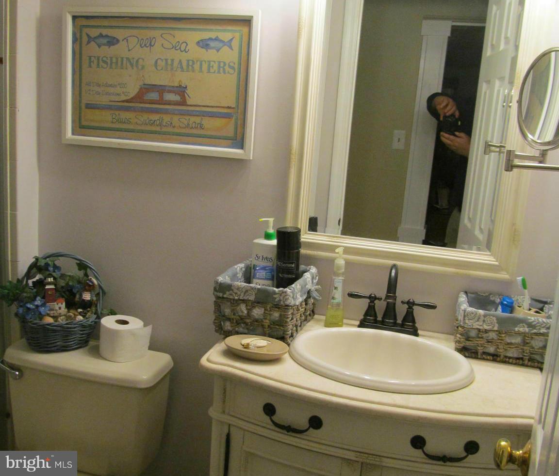 54 Yew Road Baltimore, MD 21221 - Photo 17 of 28 a bathroom with a toilet sink and mirror