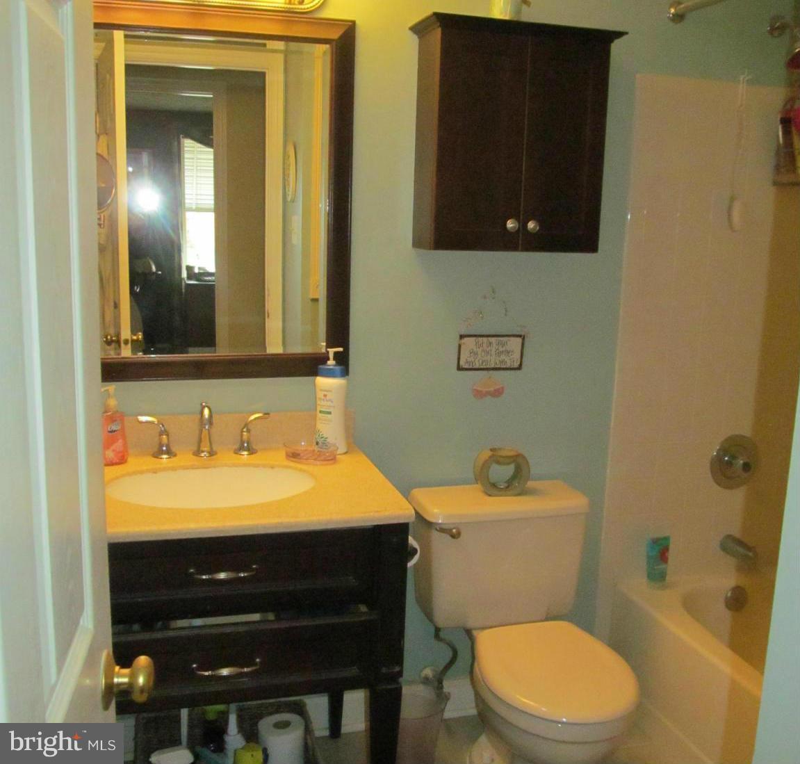 54 Yew Road Baltimore, MD 21221 - Photo 21 of 28 a bathroom with a sink a toilet and mirror