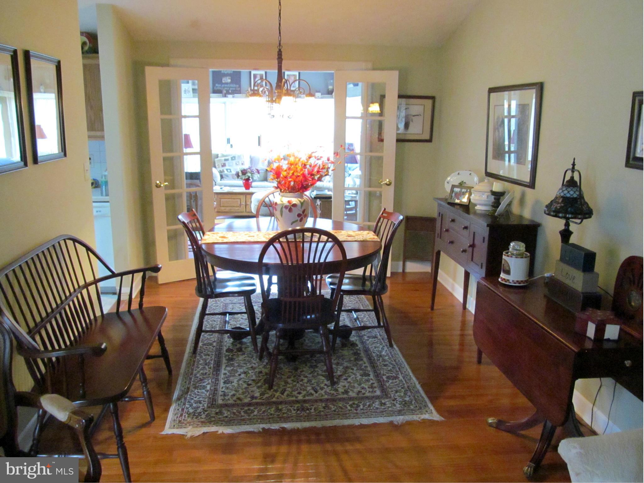54 Yew Road Baltimore, MD 21221 - Photo 6 of 28 a dining room with furniture a chandelier and wooden floor