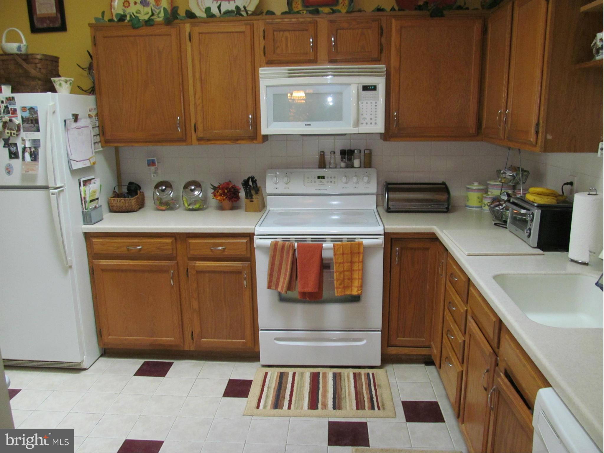 54 Yew Road Baltimore, MD 21221 - Photo 10 of 28 a kitchen with stainless steel appliances granite countertop a sink and cabinets